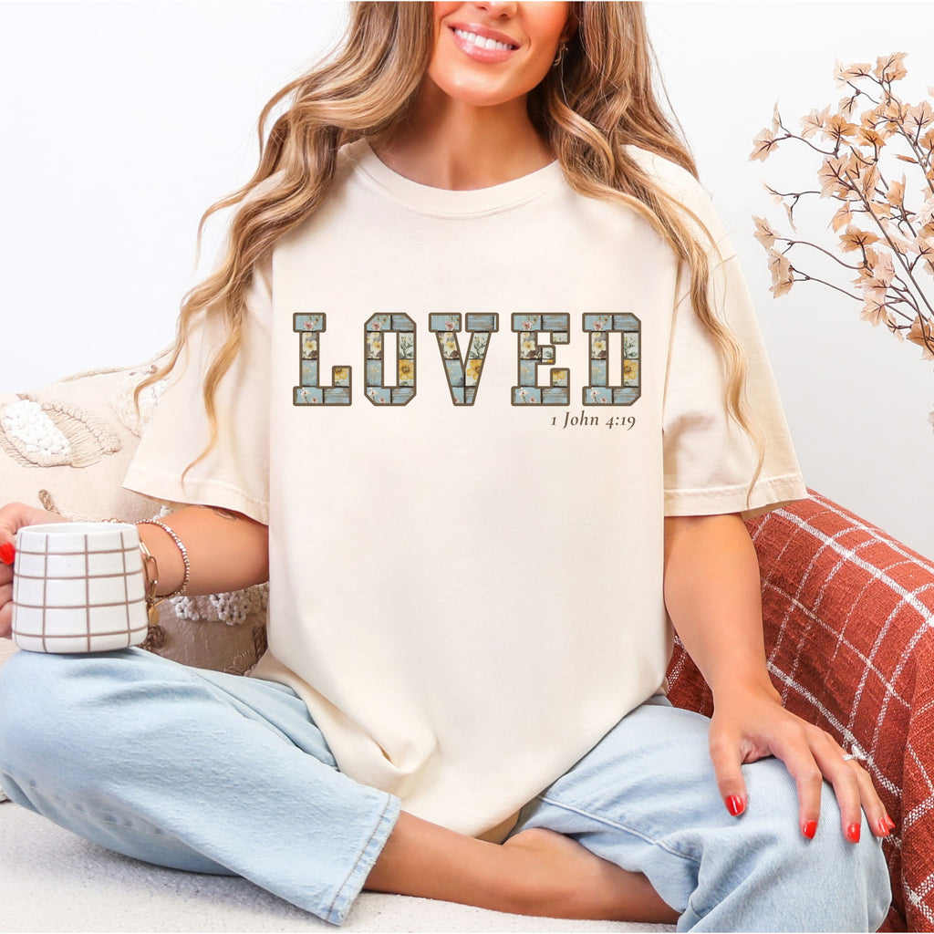 Loved Christian Tee – 1 John 4:19 Faith Graphic Shirt