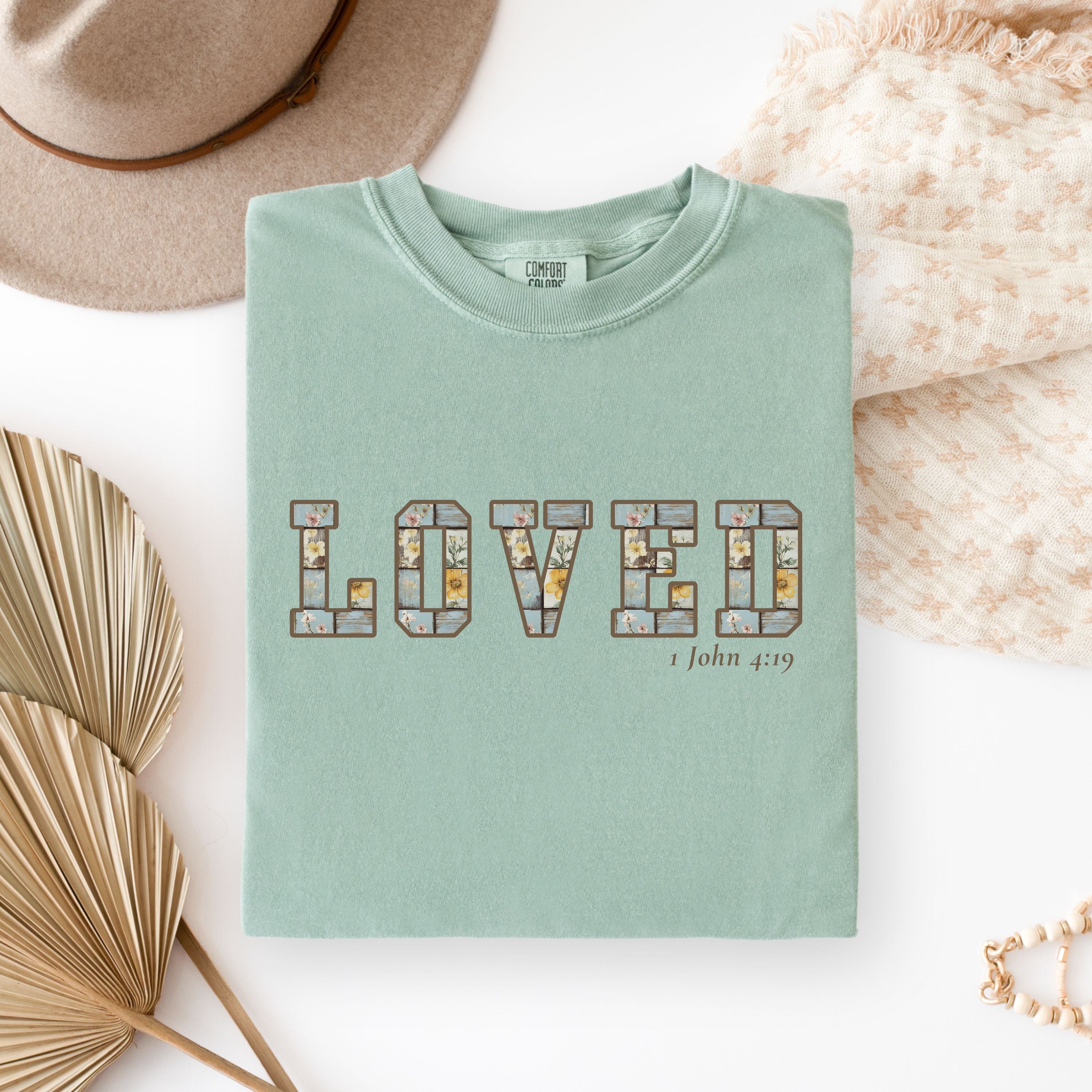 Loved Christian Tee – 1 John 4:19 Faith Graphic Shirt